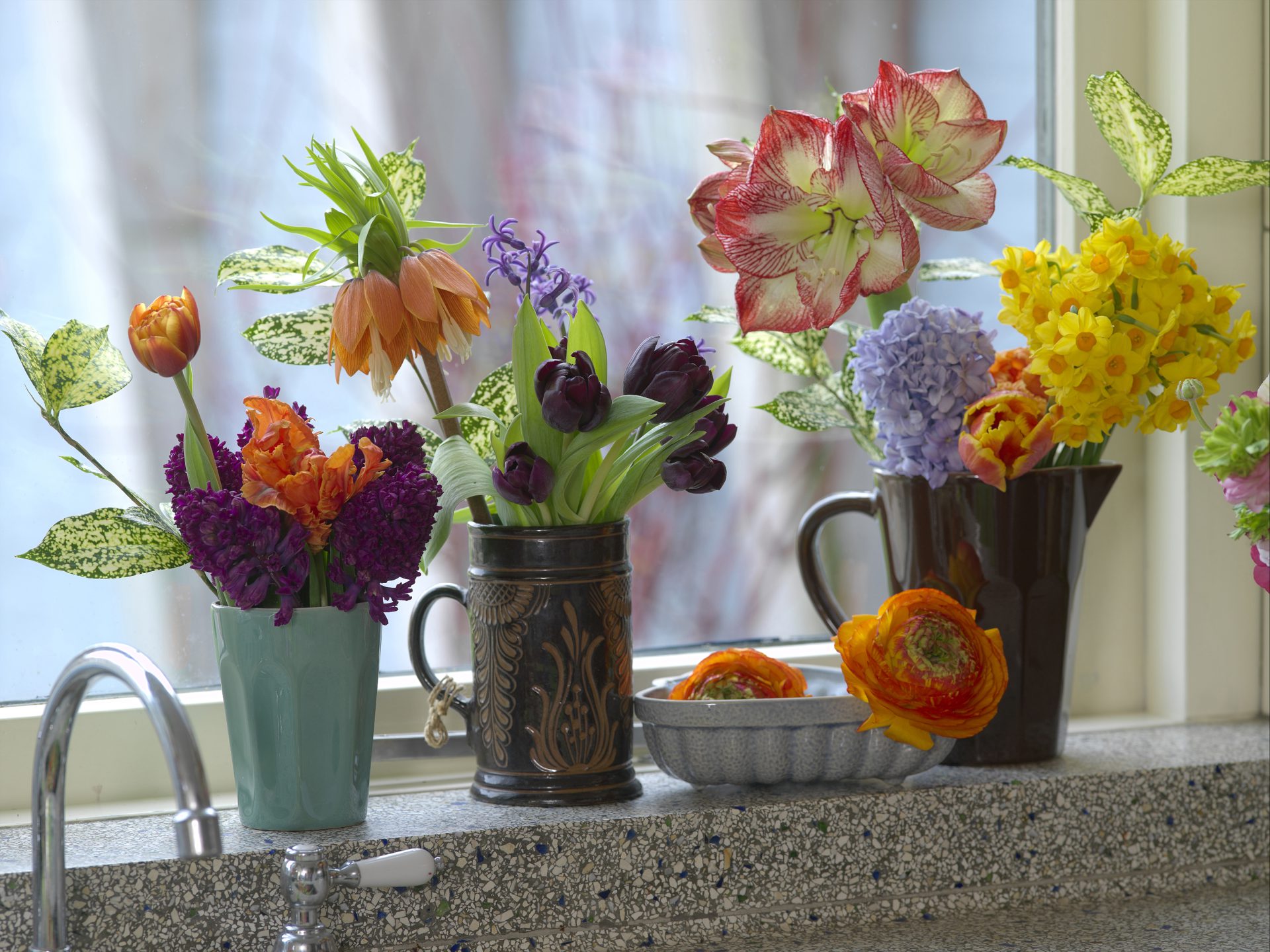 Assorted Fresh Cut Flowers in three vases.